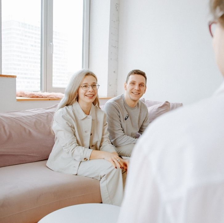 A couple meet with a legal professional to discuss their living arrangements and future plans.